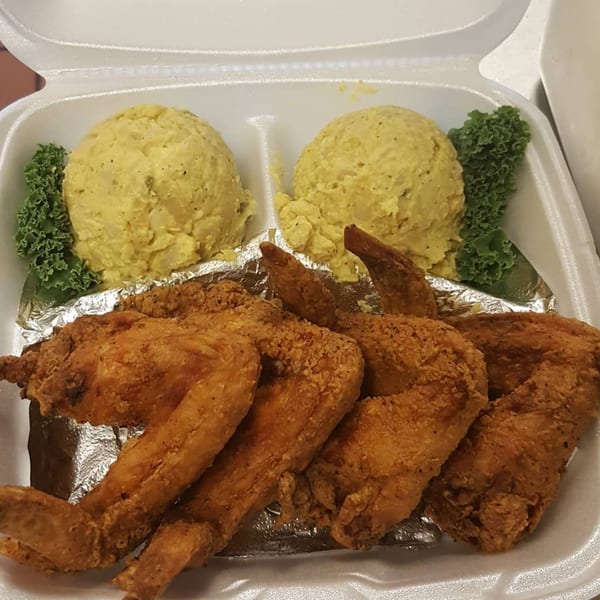 L&G Southern Soul Food's fried chicken wings and potato salad in a takeout container.
